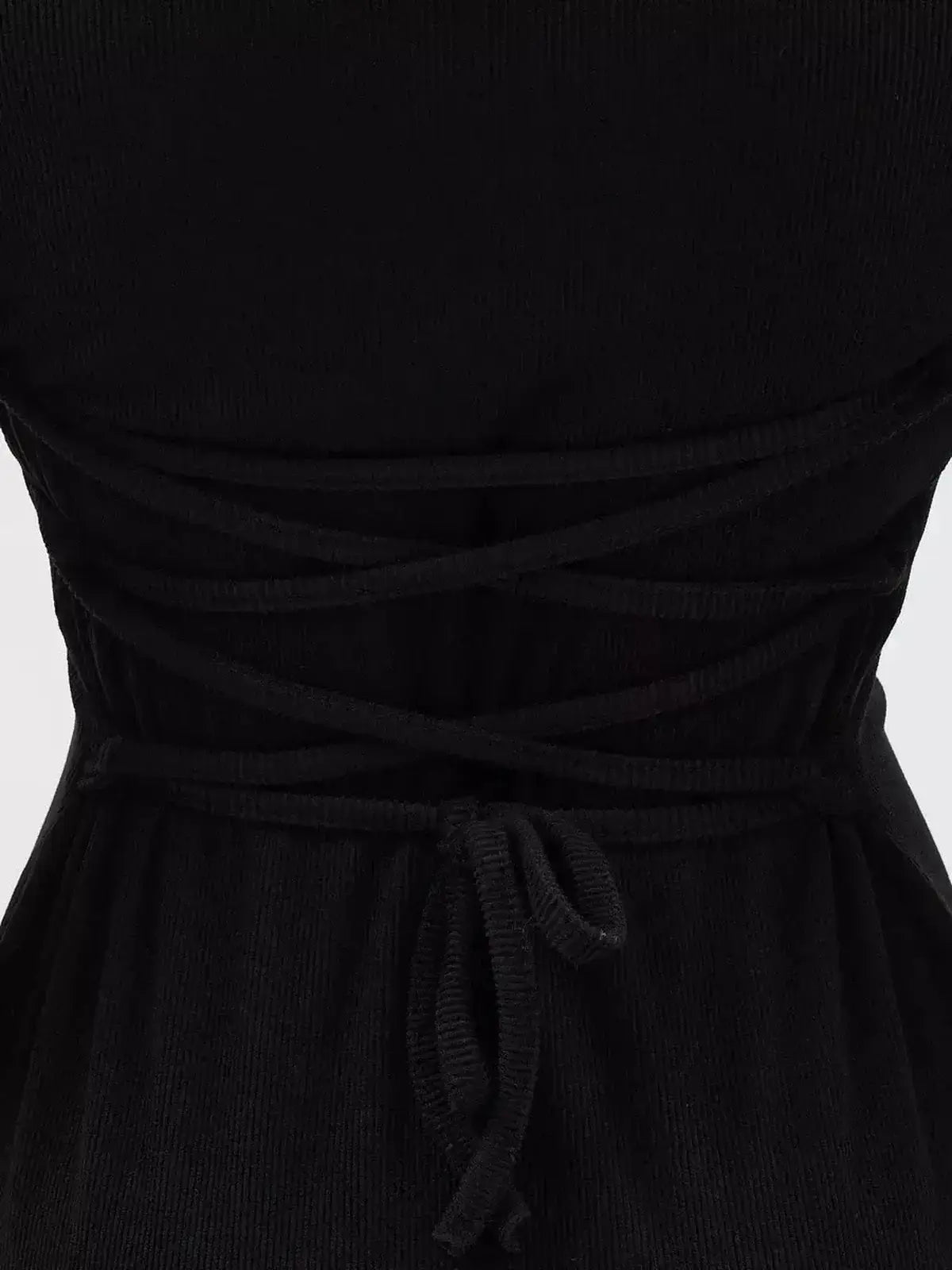 Back view of a Noir Flare Mini Dress featuring a tie waist and crisscross detail, perfect for elegant occasions.