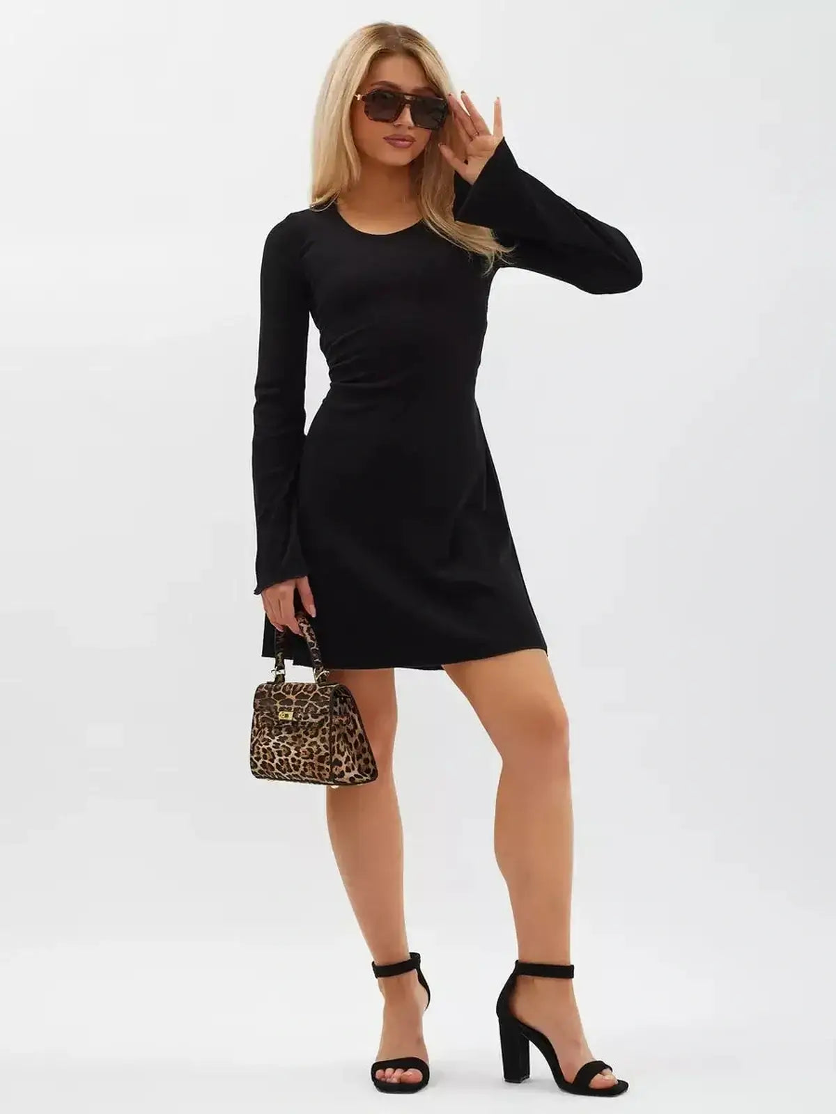 Noir Flare Mini Dress featuring long flared sleeves, a tie waist, and elegant black knit design, perfect for versatile styling.