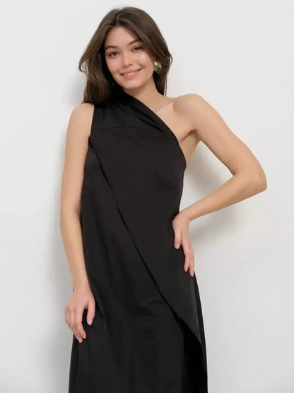 Model wearing a Noir Fold Maxi Dress featuring a one-shoulder design and draped silhouette.