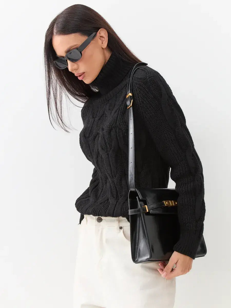 Woman wearing Noir Knitwear by Lauven, a cozy black chunky cable-knit turtleneck sweater.