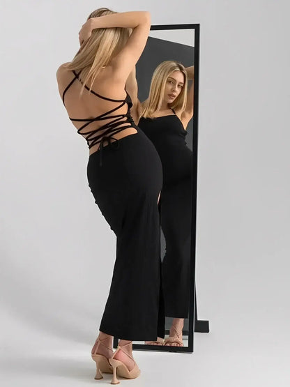 Model showcasing the Noir Lace Midi Dress by Lauven featuring an open lace-up back and thigh-high slit.