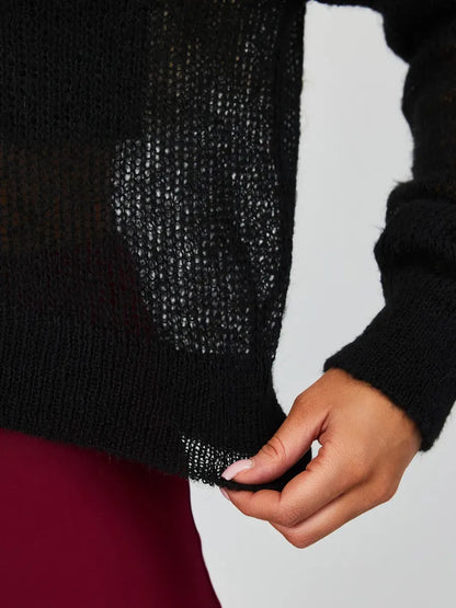 Detail of a woman wearing the Noir Luxe Cardigan from Lauven, showcasing the semi-transparent knit texture in elegant black.