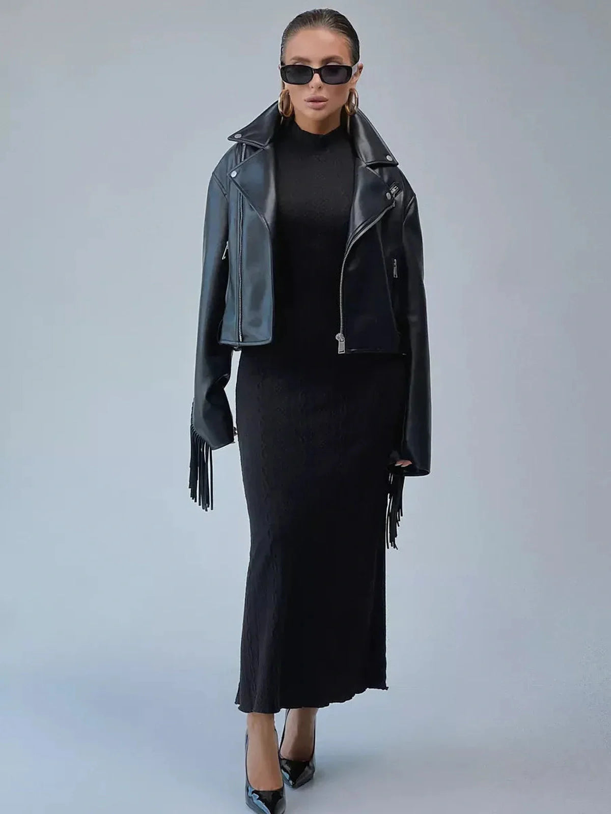Fashion model in the Noir Sculpt Maxi Dress with leather jacket and sunglasses, embodying modern elegance.