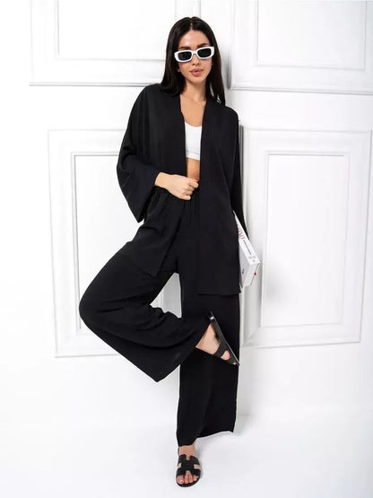 Stylish model wearing Noir Suit Set by Lauven, showcasing chic oversized black two-piece outfit with wide-leg trousers.