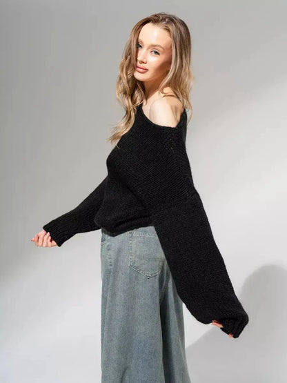 Model showcasing the Lauven Noir Sweater, an oversized off-shoulder knit in classic black.