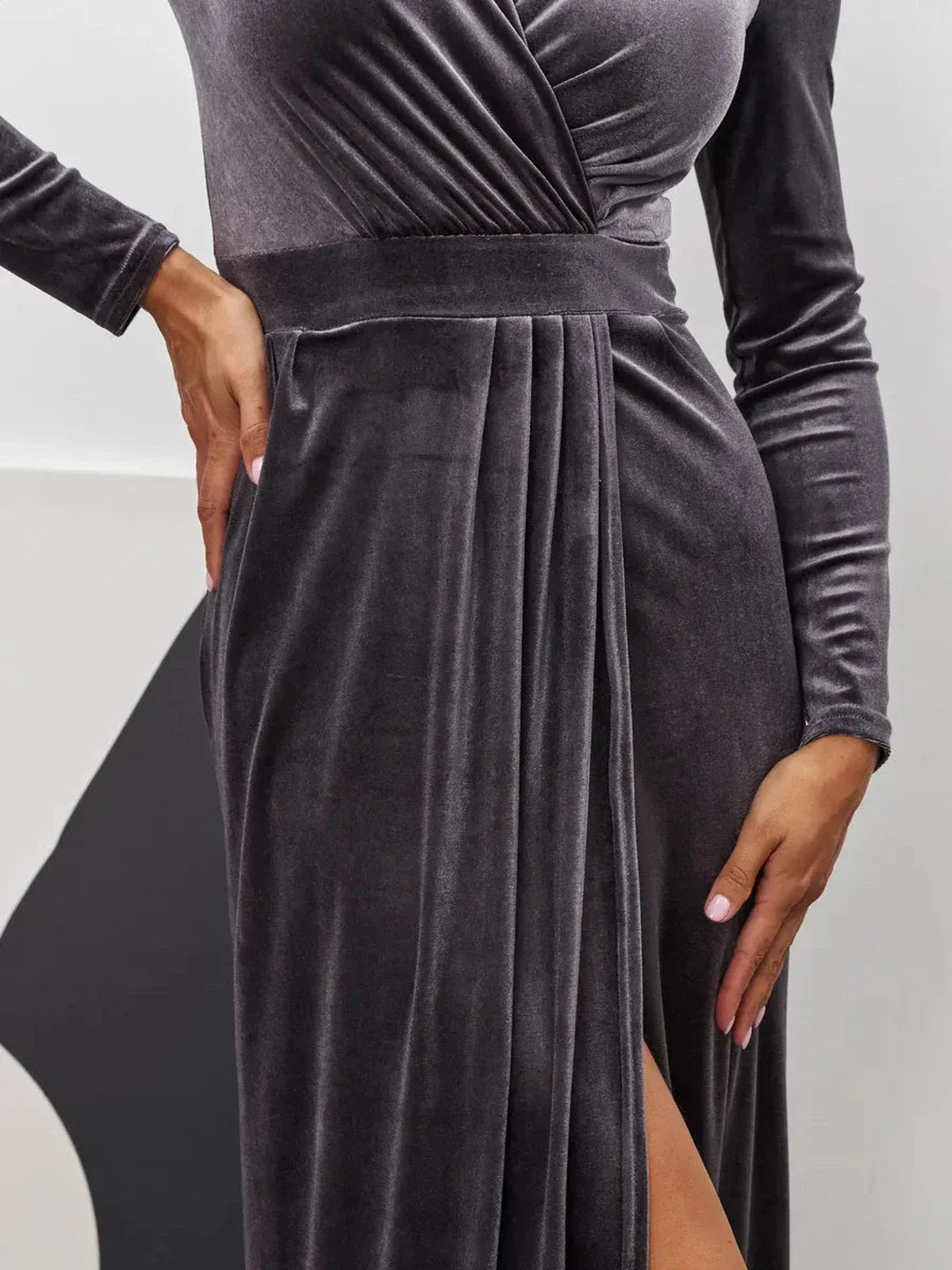 Close-up of the Noir Whisper Maxi Dress, showcasing plush graphite velvet and a thigh-high slit for a luxurious, elegant look.