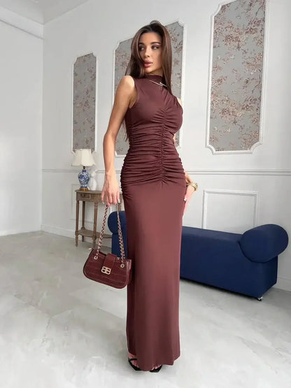 Elegant woman in a chocolate-toned Noircocoa Maxi Dress with sculptural ruching and a sleek silhouette.