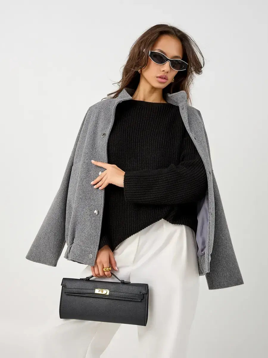 Nola Sweater by Lauven, oversized black knit pullover worn with gray coat and sunglasses, perfect for stylish winter outfits.