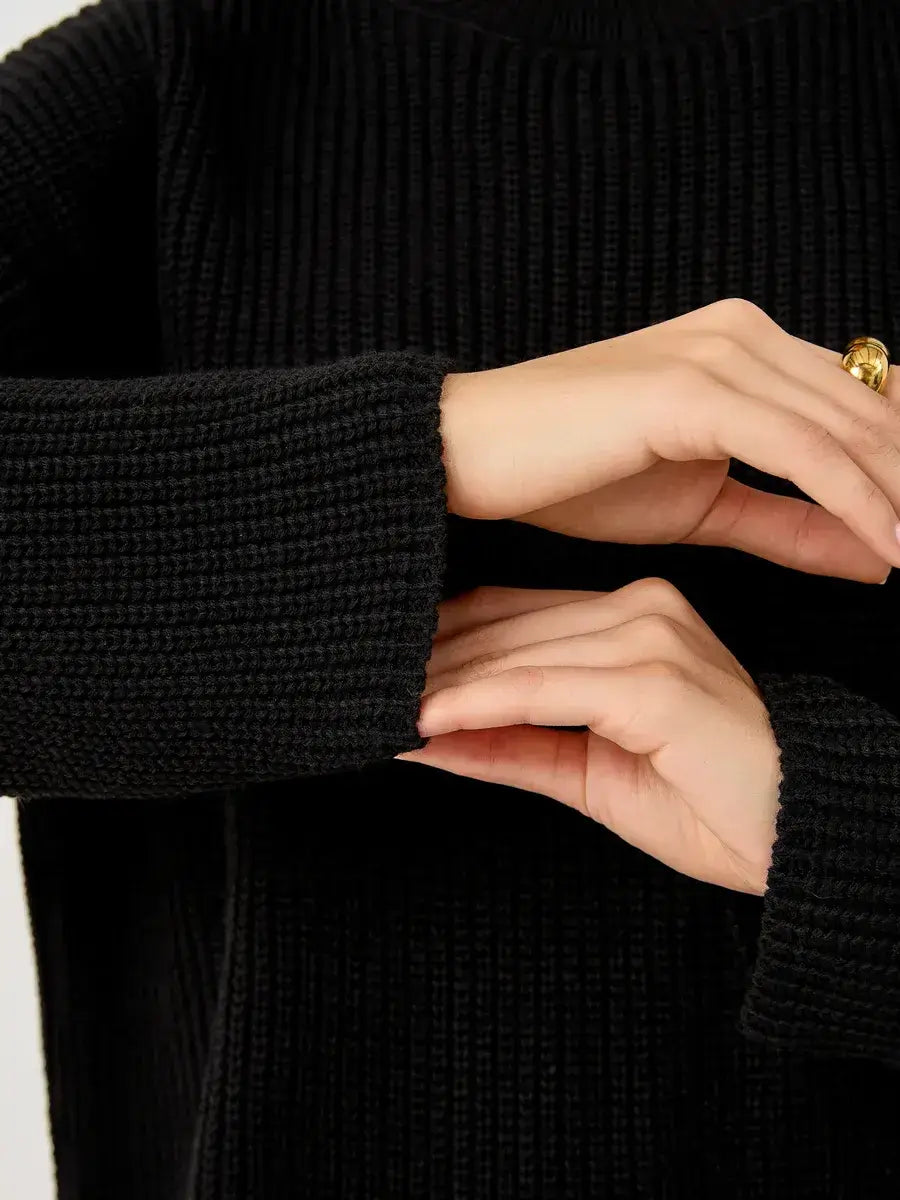 Close-up of hands showcasing the chunky ribbed cuffs of the Nola Sweater by Lauven.