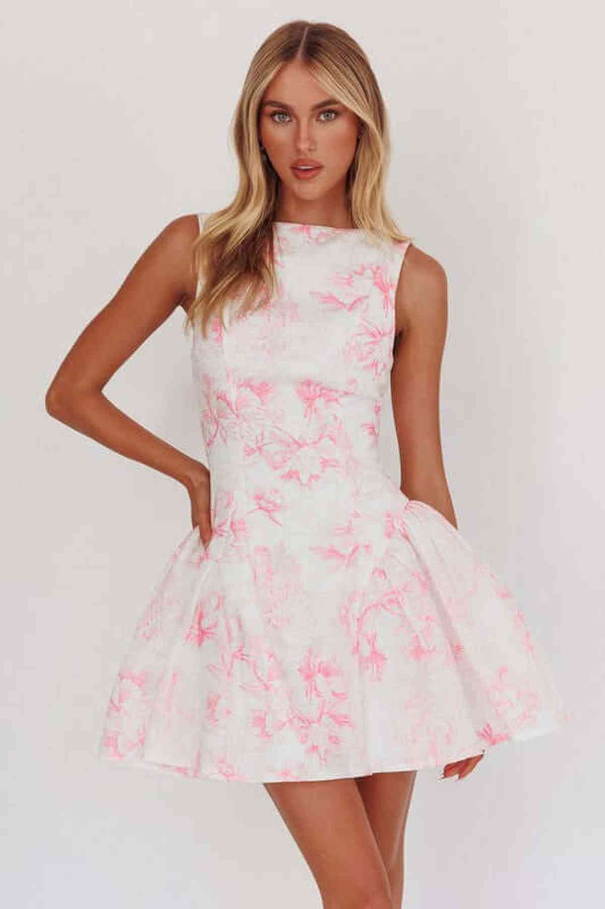 Elegant white mini dress with pink floral design, perfect for casual or formal occasions such as weddings and parties.
