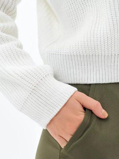 Close-up of the rib-knit sleeve of the Lauven Nova Sweater in white, highlighting its cozy elegance.