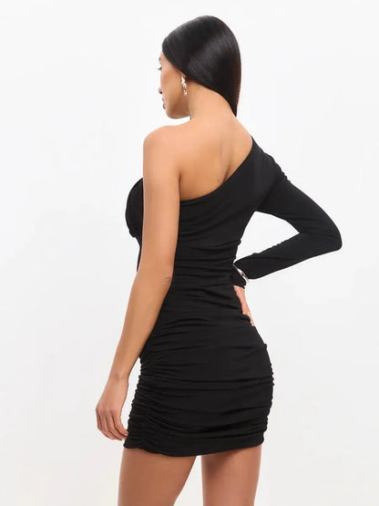 Back view of a black one-shoulder mini dress with ruching, showcasing modern elegance and figure-flattering design.