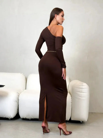 Model showcasing the Obsidian Curve Maxi Dress, a chocolate brown one-shoulder evening dress with a sleek silhouette.