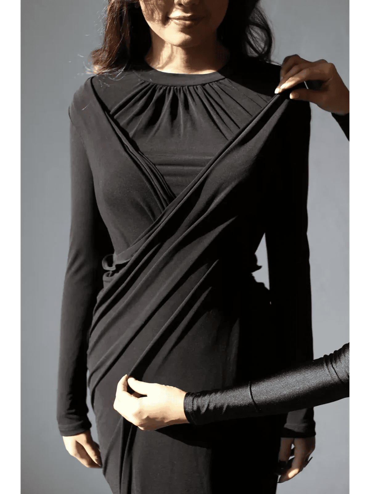 Model showcasing the Obsidian Drape Maxi Dress, highlighting its elegant silhouette and gathered high neckline.