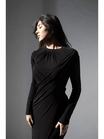Elegant woman in an Obsidian Drape Maxi Dress with a high neckline and gathered detail.