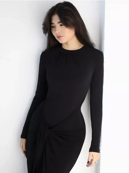 Model wearing an Obsidian Drape Maxi Dress with a high neckline and flattering knot detail.