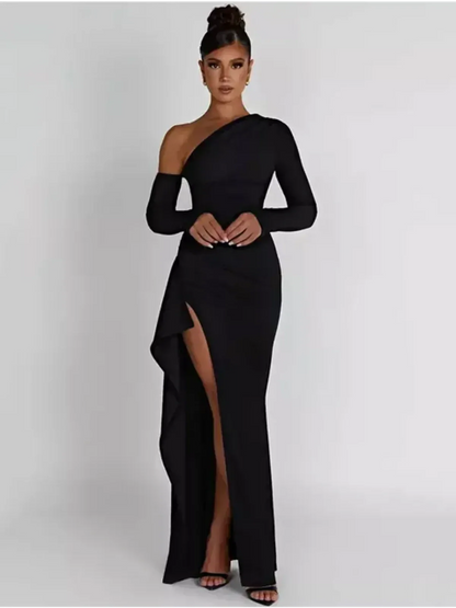 Woman wearing the Obsidian Grace Maxi Dress, featuring a daring slit and asymmetric one-shoulder design.