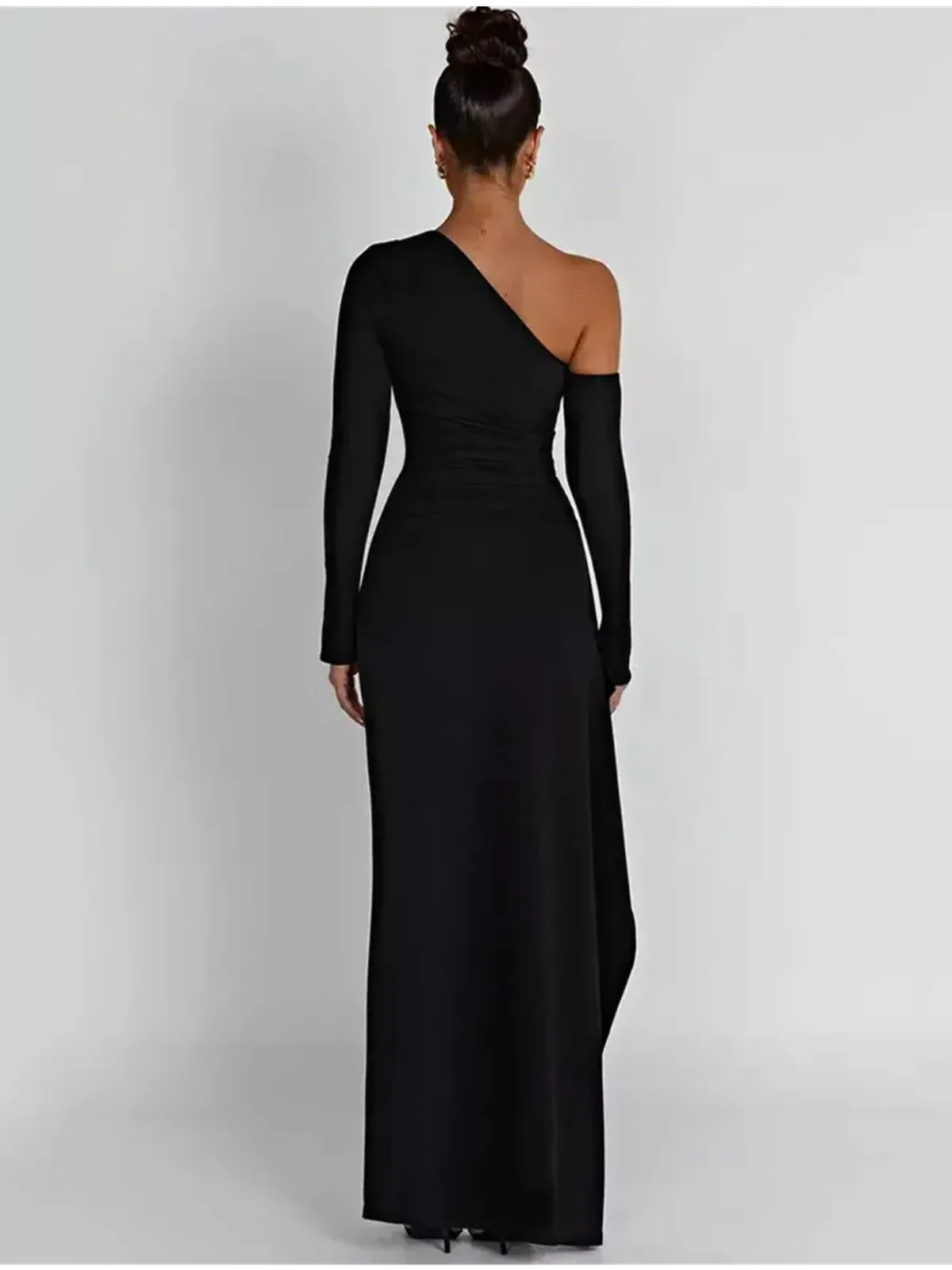 Back view of the Obsidian Grace Maxi Dress, showcasing its one-shoulder design and sleek silhouette.