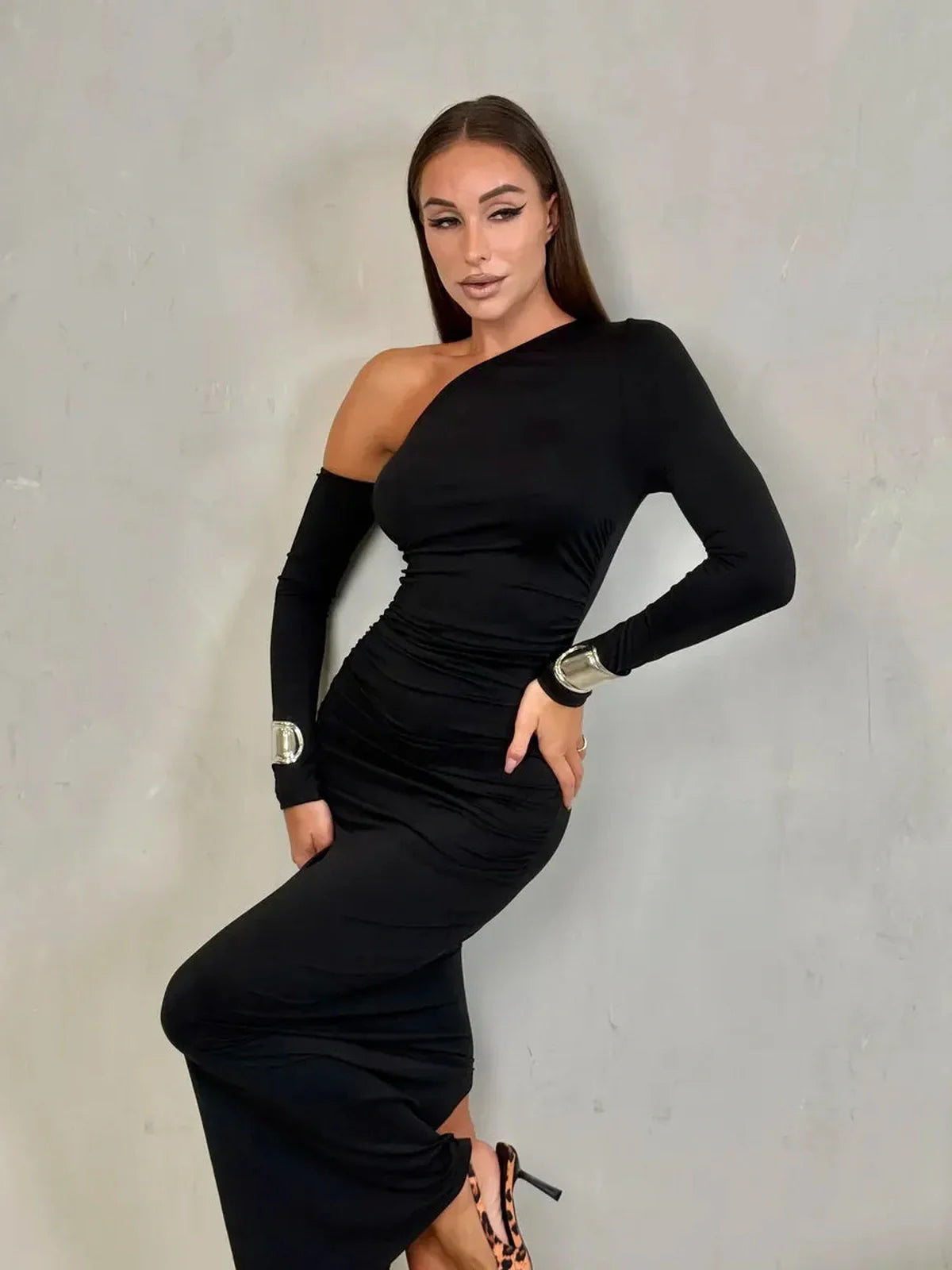 Model showcasing the Obsidian Maxi Dress with an asymmetric neckline and sleek silhouette, exuding evening elegance.