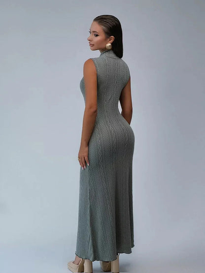 Woman wearing an elegant sleeveless Obsidian Veil Maxi Dress showcasing a cable-inspired texture from the back.