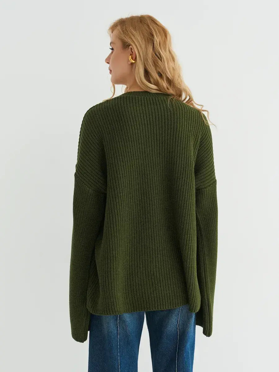 Back view of a woman wearing the Olive Sweater by Lauven, showcasing its oversized knit design in deep khaki.