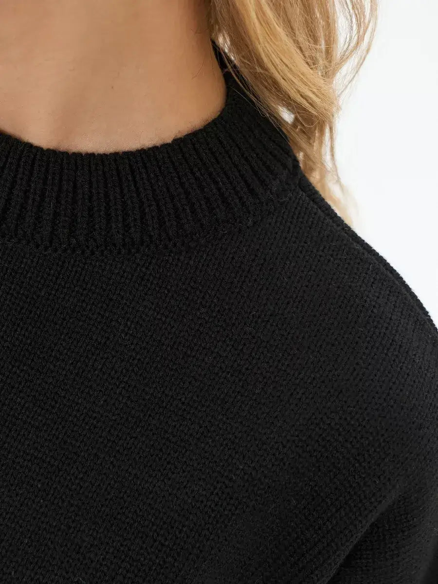 Close-up of the collar on the Onyx Sweater by Lauven, featuring a black cropped oversized knit design.