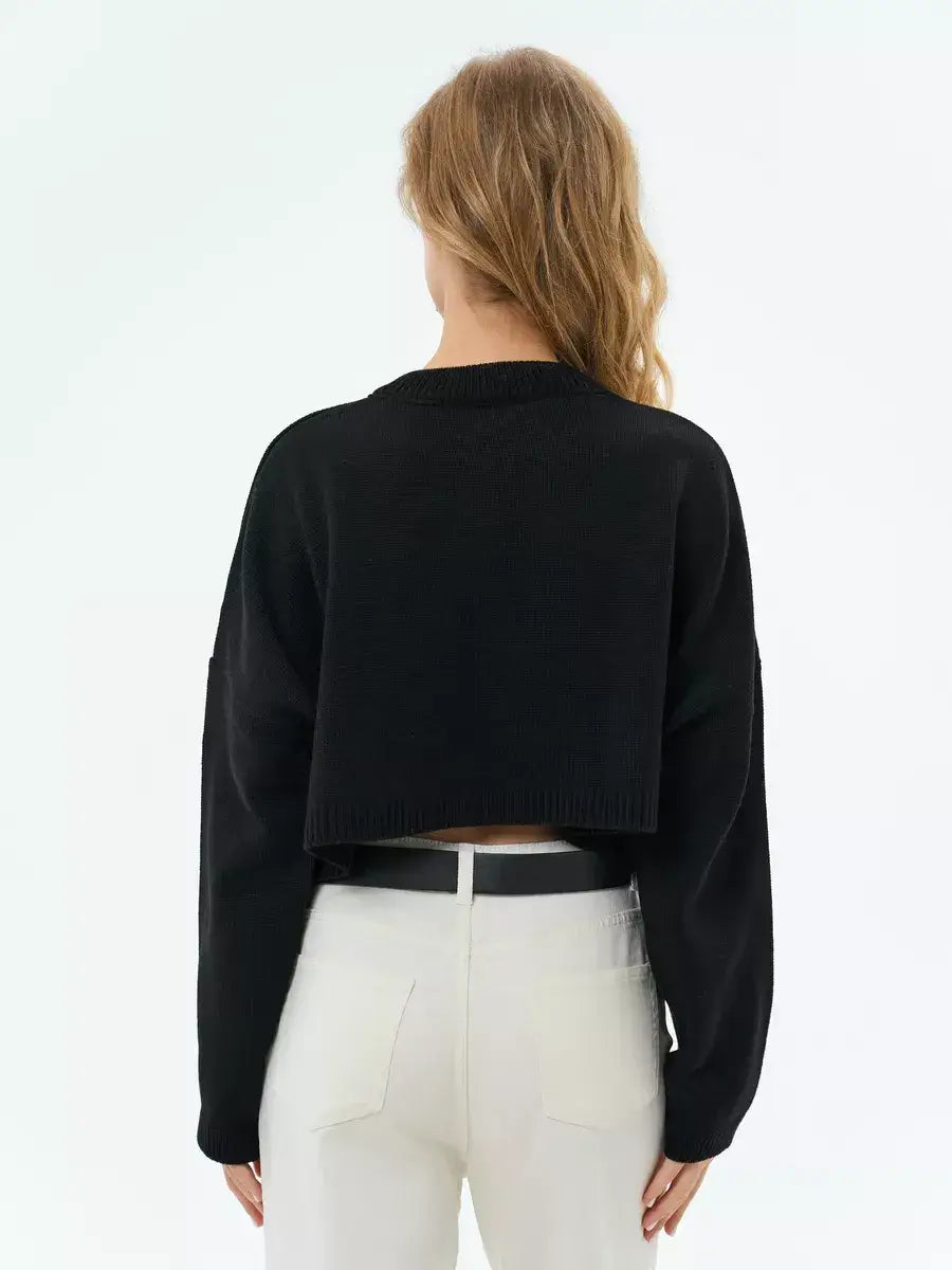 Back view of the Onyx Sweater by Lauven, a cropped oversized black knit designed for a chic, minimalistic style.