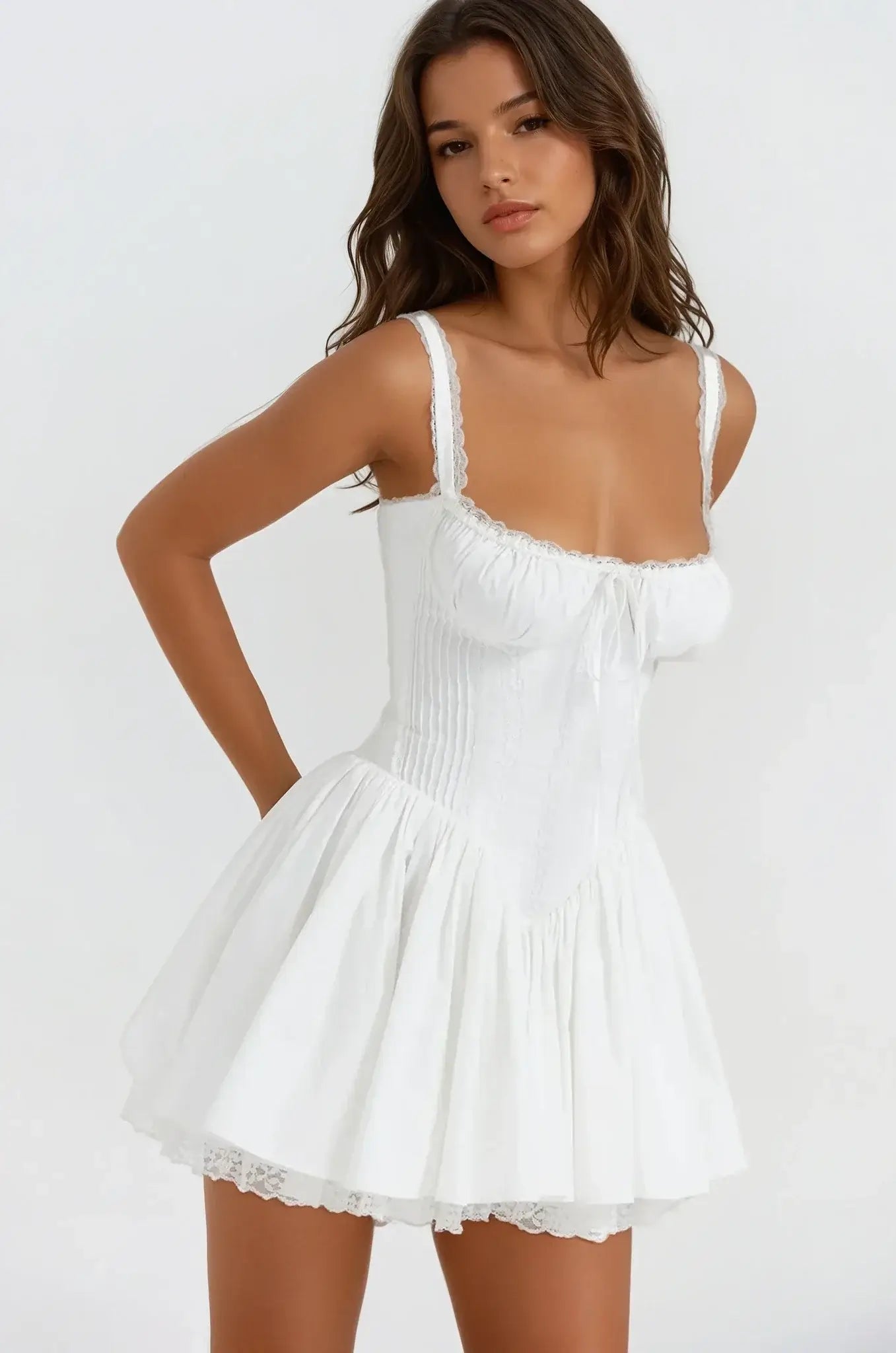 Elegant white mini dress featuring delicate lace details and a flowing silhouette, perfect for summer and special occasions.