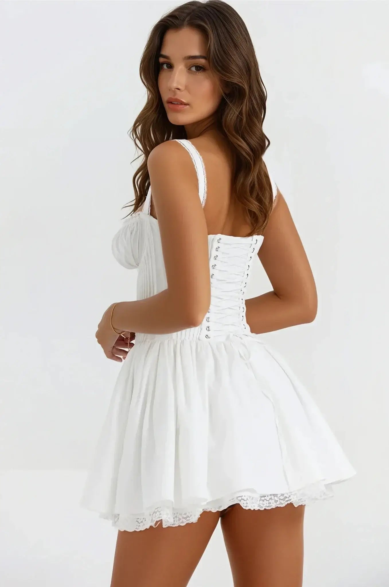 Elegant white mini dress with a flowy silhouette and lace details, perfect for summer weddings and formal occasions.
