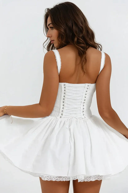 Elegant white mini dress with a flowy silhouette and lace detailing, perfect for weddings or summer events.