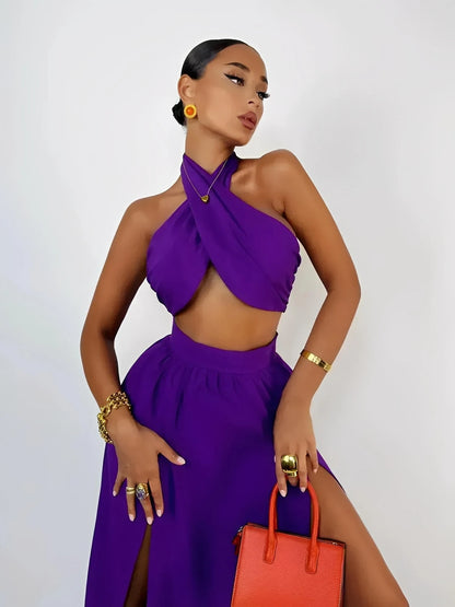 Model in a vivid orchid purple halter top and high-slit maxi skirt, exuding summer elegance and style.