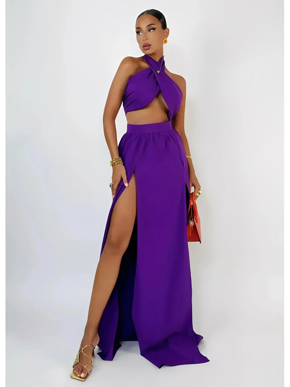 Model wearing a vibrant orchid purple halter top and high-slit maxi skirt set, showcasing a chic summer style.