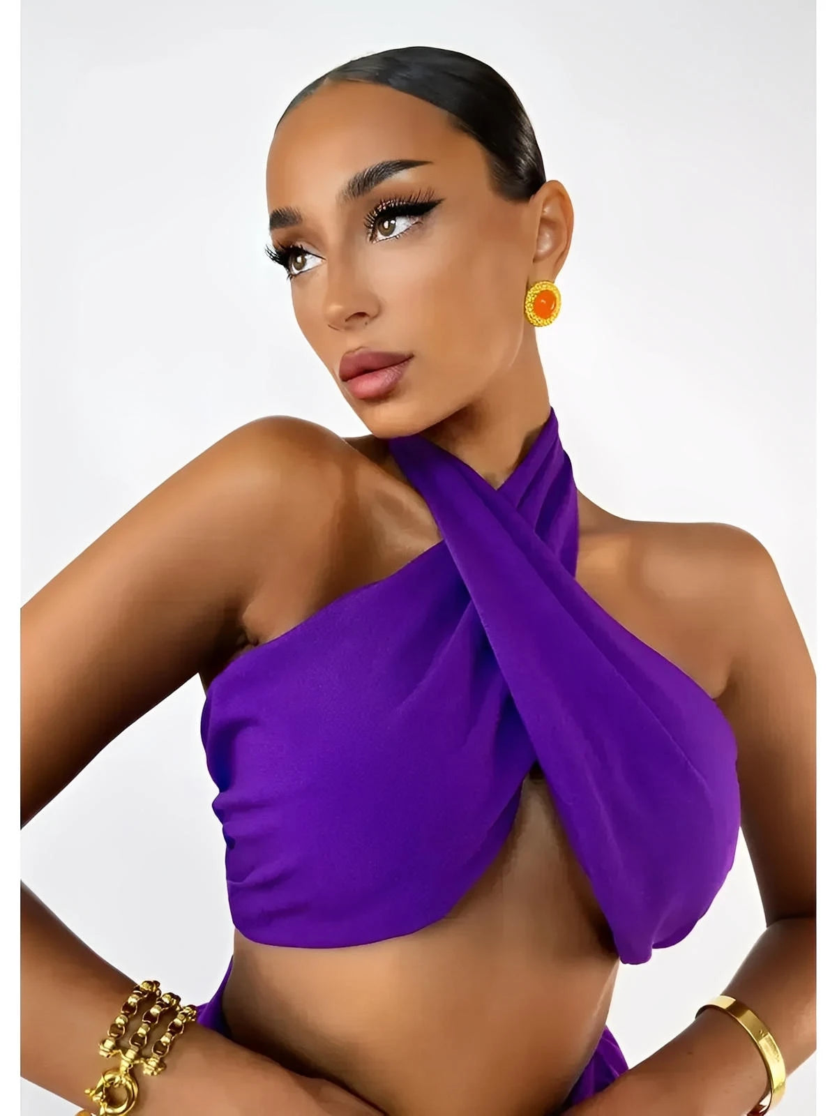 Model showcasing a vibrant orchid purple halter top with a wrap design from the Orchid Drape Set.