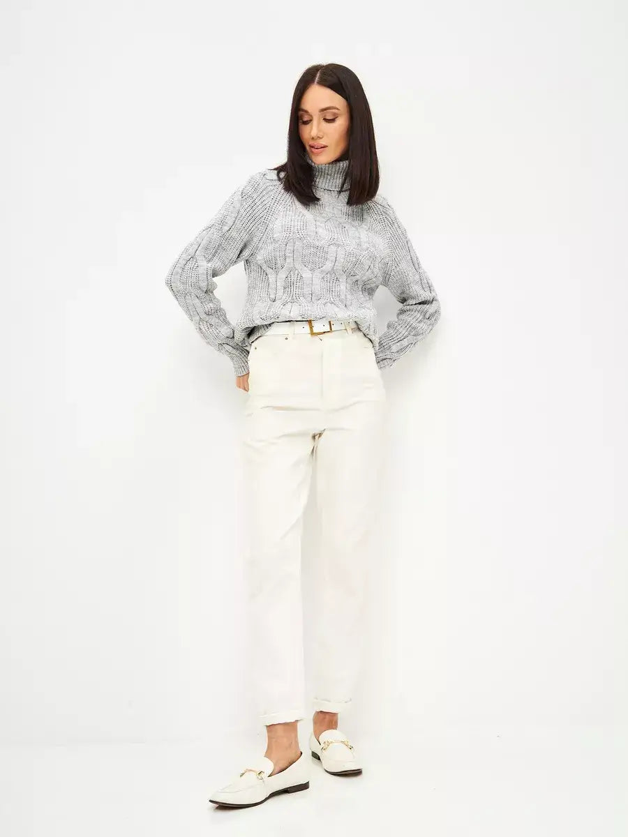 Osiris Sweater by Lauven, oversized cable knit with high neck, styled with white pants and shoes.