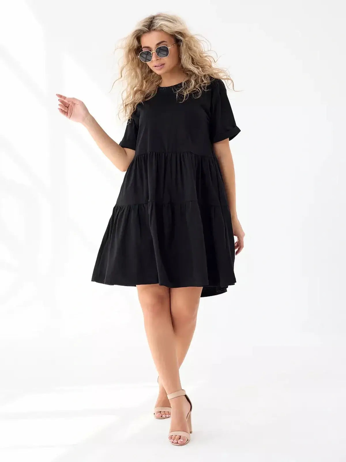 Oversized black mini dress with tiered silhouette, perfect for summer days and stylish casual wear.