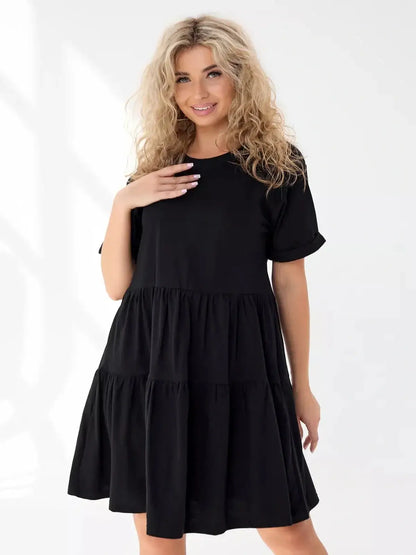 Stylish black mini dress with tiered silhouette, perfect for summer and casual occasions.