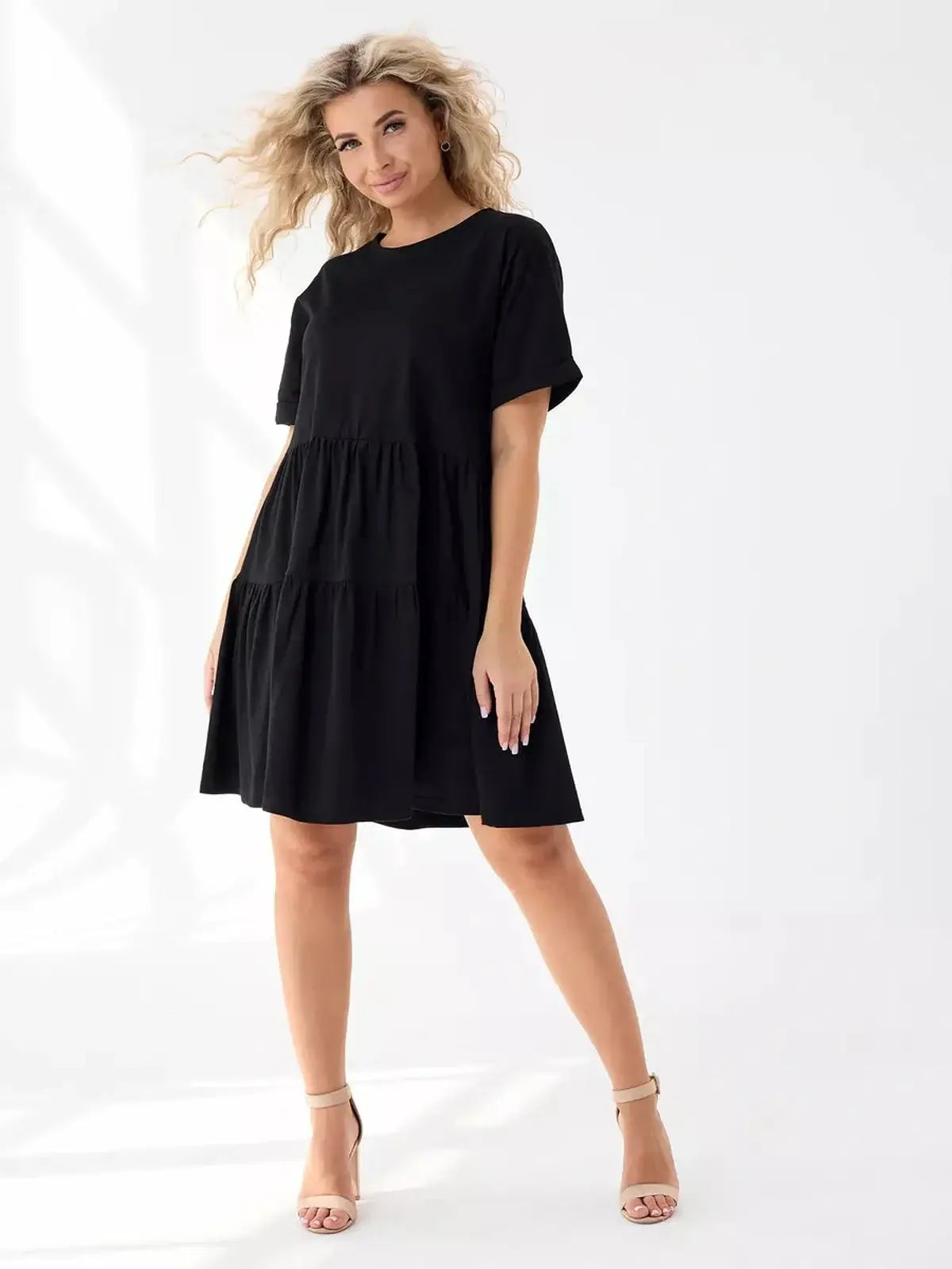 Effortlessly stylish black tiered mini dress, perfect for summer, featuring a relaxed fit and flowing silhouette.