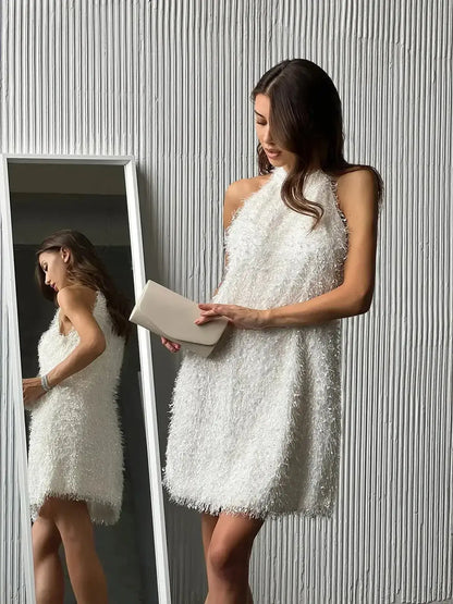 Model in a stylish white Pearl Halo mini dress with textured fringe, perfect for summer parties or wedding guest attire.