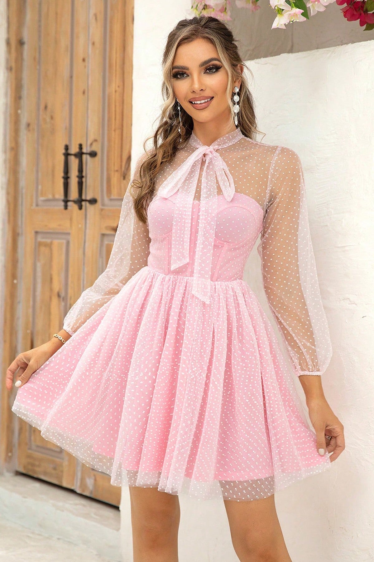 Flirty pink Pearl Mini Dress with polka dot mesh overlay and sheer bow tie collar, perfect for summer weddings and formal occasions.