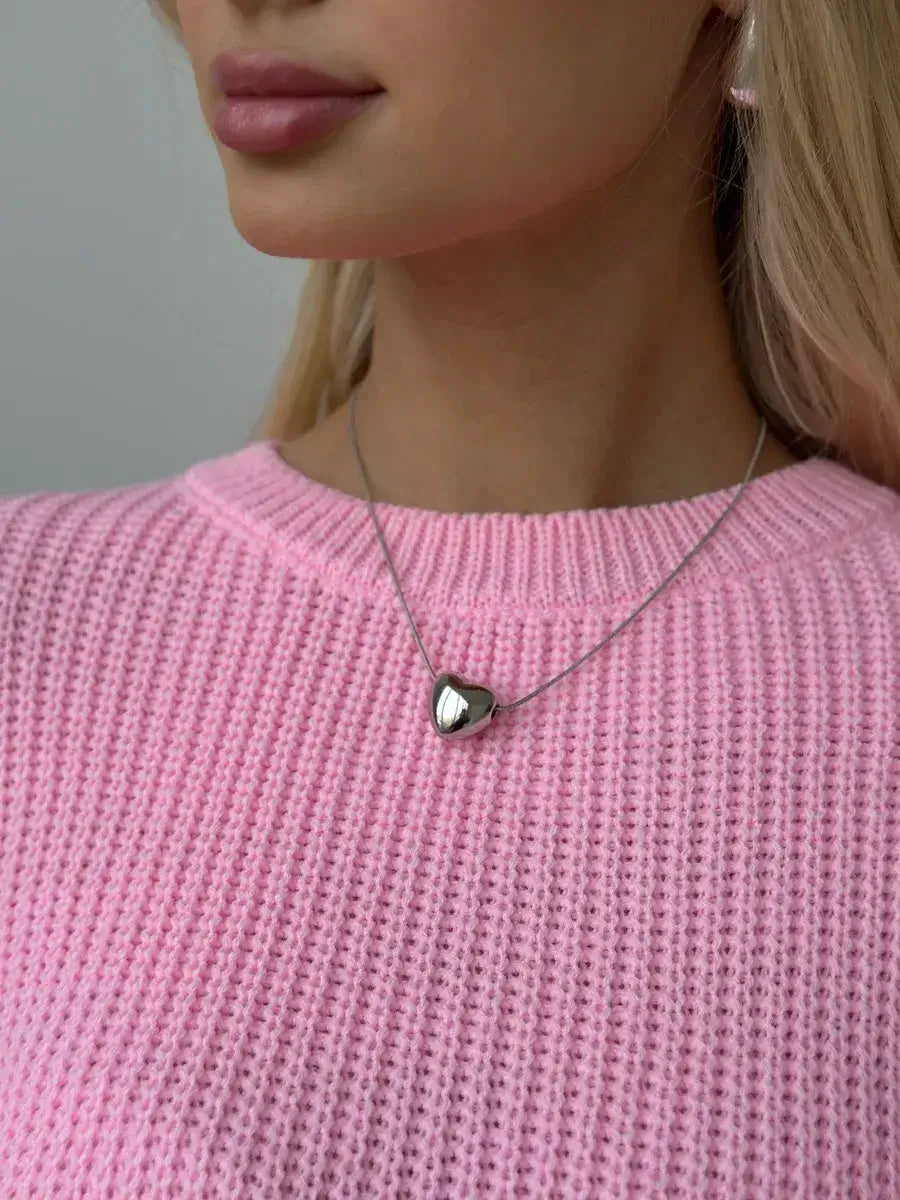 Poppy Sweater by Lauven, oversized light pink knit with a relaxed fit and crew neck, worn with a silver heart necklace.