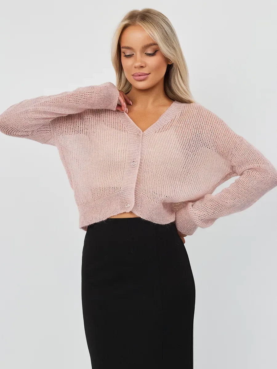 Model wearing a soft pink Rose Cardigan by Lauven, showcasing its oversized mohair-blend design with dropped shoulders.
