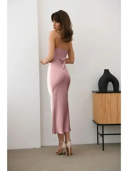Model wearing the Roselle Midi Dress in muted rose, showcasing its sleek silhouette and satin fabric.