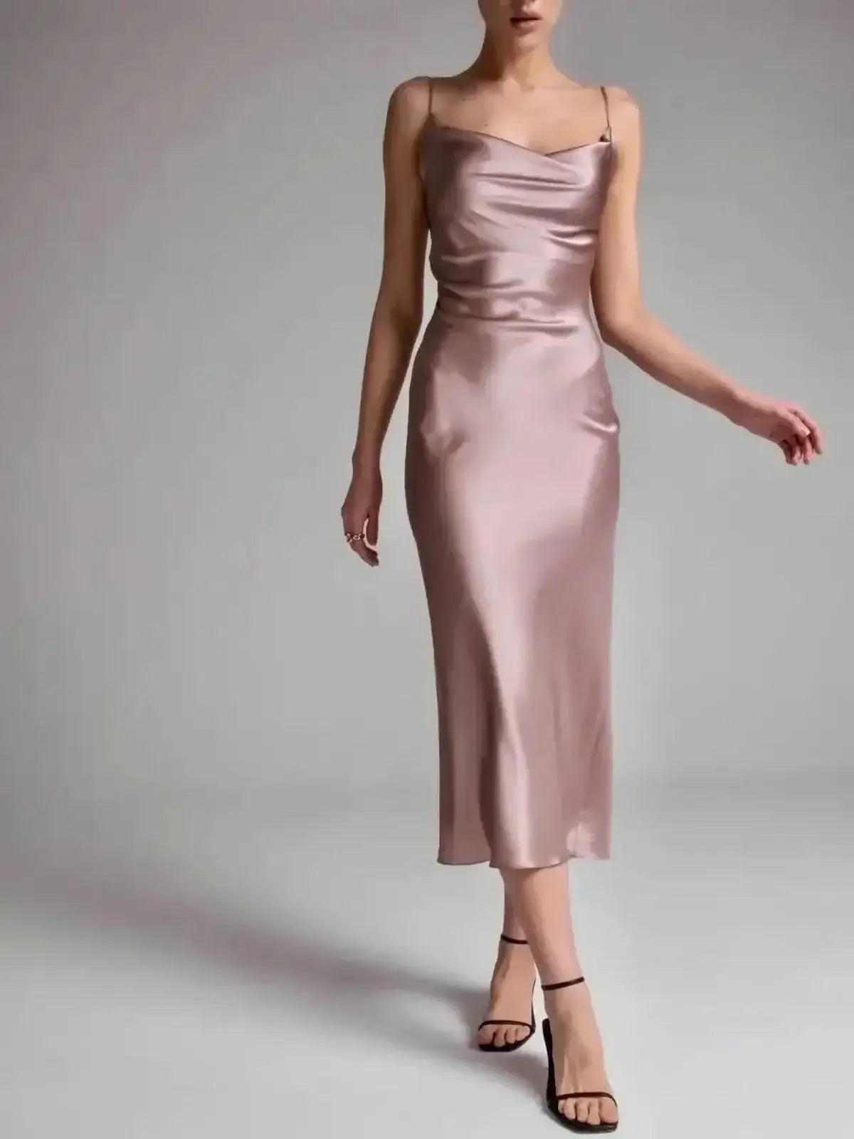 Sleek Roselle Midi Dress in muted rose satin, featuring elegant draping and a flattering silhouette for evening occasions.