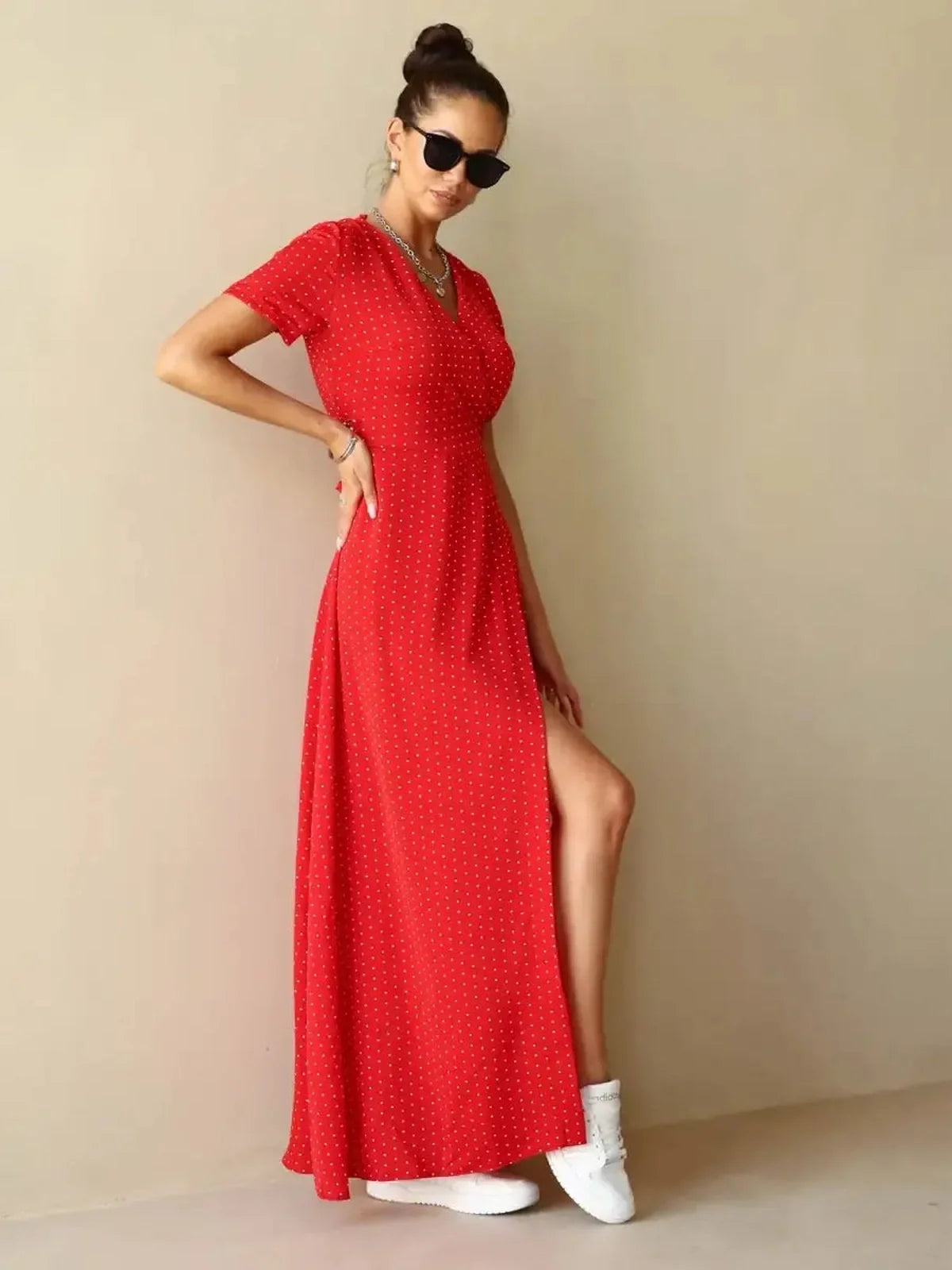 Ruby Grace Maxi Dress in vibrant red polka dots featuring V-neckline, adjustable waist tie, and side slit for ease of movement.
