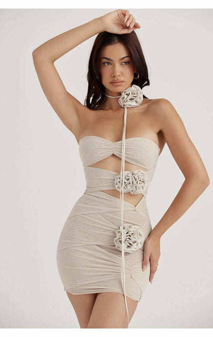 Model wearing a stylish Ruby Mini Dress with cut-out details and rose embellishments, perfect for special occasions.