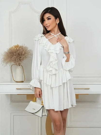 Elegant woman wearing a white Ruffle Bloom Mini Dress with romantic ruffles, perfect for summer events.