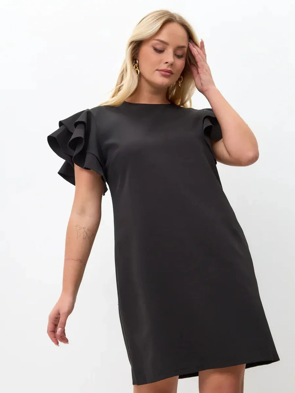 Black mini dress with layered ruffle sleeves, combining elegance and comfort for warm-weather wear.