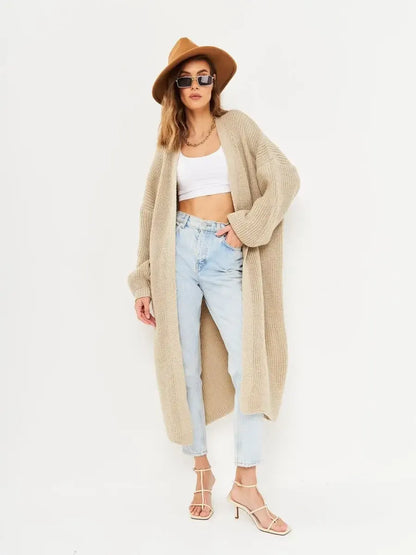 Sable Cardigan by Lauven featuring a model in a long oversized knitwear coat, styled with a crop top and jeans.