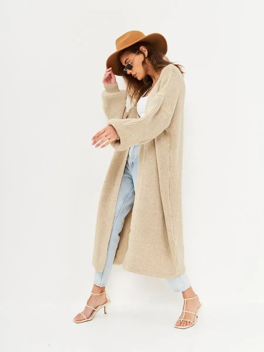 Model wearing Sable Cardigan from Lauven, a long oversized knitwear coat in beige.