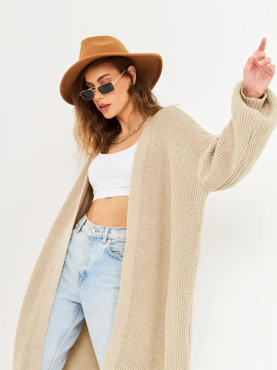 Woman wearing Sable Cardigan by Lauven with wide-brimmed hat and sunglasses, showcasing stylish autumn outfit.